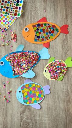 three fish made out of paper and sprinkles