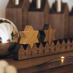 a christmas ornament on top of a wooden table next to other ornaments and decorations