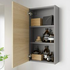 an open cabinet door in a bathroom with soaps and lotions on the shelves