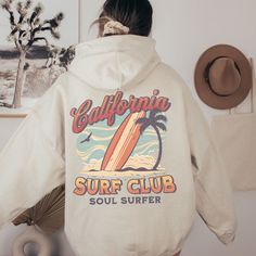 California Surf Club Hoodie, the perfect beachy sweatshirt for surf enthusiasts and coconut girls alike. This summer hoodie captures the essence of California's surf culture with its laid-back style and vibrant design. Made with high-quality materials, this surf hoodie is not only stylish but also comfortable, making it ideal for those breezy beach days or cozy nights by the bonfire. Channel your inner surfer with the California Surf Club Hoodie and embrace the carefree spirit of the California coast. 🖤 For oversized order 1-3 sizes up, refer to listing photos for sizes. RUNS ON THE SMALLER SIDE 🖤 Gildan 18500 🖤 Some Shrinkage may occur with washing 🖤 This unisex heavy blend hooded sweatshirt is relaxation itself.  🖤 Made with a thick blend of cotton and polyester, it feels plush, sof Casual White Hoodie For Beach Season, Long Sleeve Cotton Hoodie For Beach Season, White Long Sleeve Hoodie For Beach Season, Casual Letter Print Hoodie For Beachwear, Sporty Cotton Hoodie For Beach, White Hoodie For Beach Season Streetwear, White Letter Print Hoodie For Beach Season, White Hooded Hoodie For Beach Season, Sporty Beach Hoodie With Letter Print