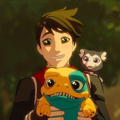 a young man holding a stuffed animal in his arms and an owl on top of him