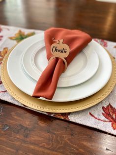 the place setting is ready to be served at this thanksgiving dinner with personalized napkins