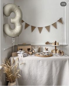 a table topped with lots of food and balloons