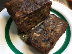 two pieces of brownie sitting on top of a green and white plate next to each other