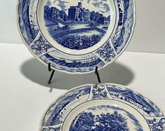 two blue and white plates sitting next to each other