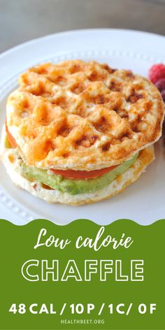 a waffle sandwich on a white plate with raspberries and green text overlay reads low calorie chaffle