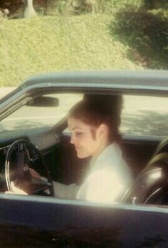 a man sitting in the driver's seat of a car