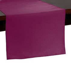 a purple table runner on top of a wooden table