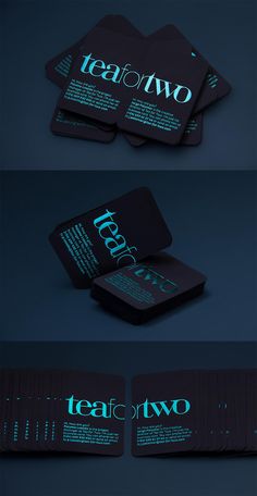 some business cards with the words teatot on them are lit up in blue