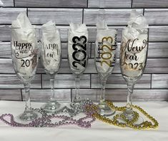 three wine glasses with happy new year on them