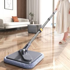 a woman is cleaning the floor with a mop