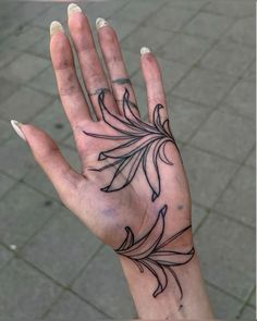 a woman's hand with a tattoo on it and the palm of her left hand