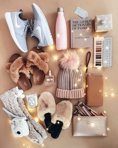 the contents of a woman's purse and shoes laid out on top of a table