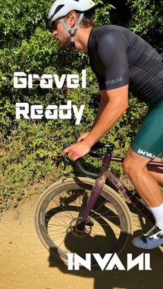 a man riding a bike down a dirt road next to green bushes and trees with the words survival ready written on it