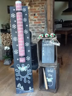 two chalkboard boards are stacked on top of each other in front of a brick wall