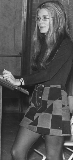 an old photo of a woman sitting at a desk