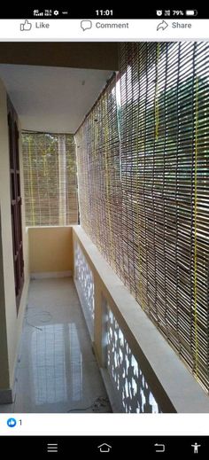 an empty hallway with bamboo blinds on the wall