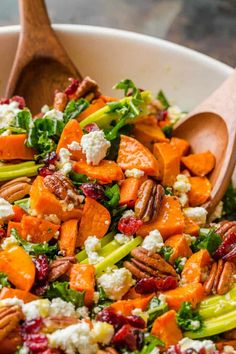 a salad with carrots, broccoli, cranberries and feta cheese