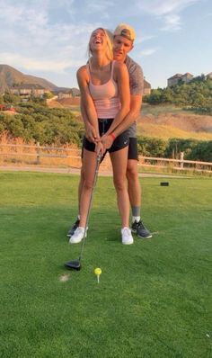 a man and woman are playing golf together