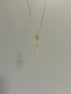 Dainty and so sparkly, our cross necklace is a classic and perfect for everyday wear! Information: ✨ Sterling Silver (925 stamped) | 14K Gold Plated ✨ AAA grade Cubic Zirconia gemstones ✨ Adjustable length: 16" - 18" ✨ Hypoallergenic ✨ Tarnish resistant ✨ Water friendly Our cross necklace is dainty, it measures roughly the size of a quarter in height. It's ideal for those that love small charms. At the center of the cross, we have added a North Star design which according to the scripture, allows people to receive guidance in their journey. The necklace has great craftsmanship and attention to detail, using a pavé design to encrust the gemstones, giving the cross a lot of shine and sparkle. Plus, the necklace is adjustable. You have the ability to wear it at 16", 17" or 18" allowing you to Dainty Cross Necklace For Baptism, White Cross Necklace For Baptism, Dainty Cross Necklace For First Communion, White Cross Pendant Necklace For Baptism, Gold Crucifix Necklace, Small Cross Necklace, Cross Necklace Gold, Cross Charm Necklace, Necklace Christian