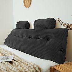 a bed that has some pillows on top of it