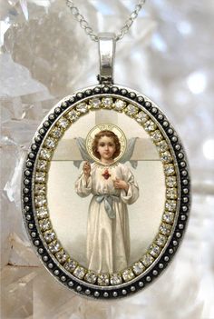 "- Holy Child Jesus - . I created this unique and meaningful necklace designs in honor of Holy Child Jesus. Express your faith and devotion with this Handmade Necklace, it's a very powerful piece and a true gift for yourself or someone special. . Created With: Beautiful 57x37mm pendant with image of Holy Child Jesus, adorned with clear rhinestones. This pendant comes with chain. Materials: Rhinestones & Metal - All medals come with prayer . Please note: This Necklace its handmade by hands th Spiritual Oval Pendant Jewelry For Commemoration, Spiritual Crucifix Necklace For Memorial, Spiritual Cross Pendant Jewelry For Commemoration, Spiritual Round Pendant For Gift, Spiritual Necklace With Miraculous Medal For Commemoration, Spiritual Crucifix Necklace For Gift, Spiritual Crucifix Necklace As Gift, Spiritual Pendant Necklace For Memorial, Handmade Spiritual Necklace For Commemoration