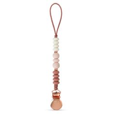 a pink pacifier is hanging from a cord with beads and a bead around it