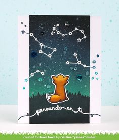 a card with a fox on it and stars in the sky behind it, as well as some grass