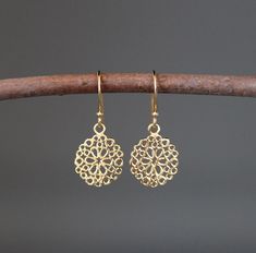 "Beautifully detailed small 24k bright gold vermeil filigree round flower charms simply dangle from 24k gold vermeil balled earwires. These lightweight go-with-everything earrings complete any outfit for daytime or evening. A matching necklace can be ordered. Gold flower charms: 12mm Total length of earrings: 1 1/8\" All gold is 24k gold vermeil. As the owner, maker, designer, and curator of this shop, I take great pride in providing you with jewelry that you will love to wear for many years to Gold Filigree Drop Flower Earrings, Delicate Gold Filigree Earrings, Dainty Gold Flower Earrings, Pierced, Traditional Gold Flower Earrings With Ear Wire, Gold Filigree Flower Earrings For Gift, Small Gold Earrings, Gold Flower Earrings, Gold Filigree Earrings, Round Flower