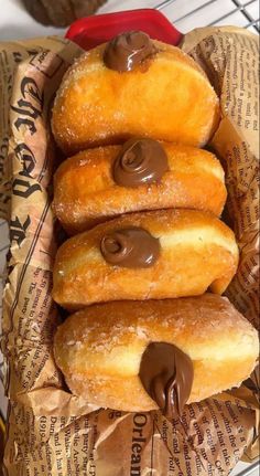 doughnuts in a basket with chocolate on top