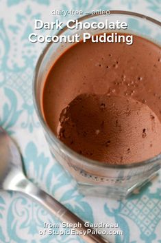 chocolate pudding in a glass cup with spoon on the side and text overlay reads dark chocolate coconut pudding