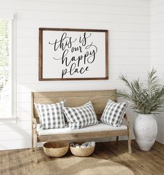 a living room with a couch and some pillows on the floor next to a potted plant