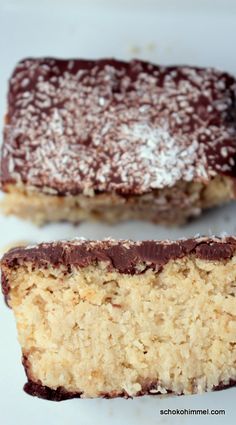 two pieces of cake sitting on top of a white plate with powdered sugar and chocolate