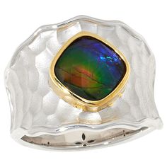 Canadian Ammolite Gems Sterling Silver Ammolite Two-Tone Hammered Ring This artistic, two-tone sterling silver ring features rainbow-colored ammolite, a rare gem from Alberta, Canada. Set into a handsome, hammered base, it's sure to make a bold style statement on your finger. By Kenneth Bradley.       Approx. 11/16"L x 5/8"W x 3/16"W; shank 3/16"W     Stamped .925     Rhodium and goldtone plating     Rng has cushion-cut ammolite triplet stone bezel-set in goldtone frame atop wide, wavy-edged ban Texture Stone, Hammered Silver Ring, Hammered Ring, Hammered Rings, Color Bands, Rare Gems, Bold Style, Alberta Canada, Style Statement