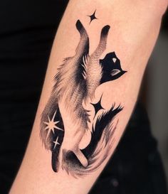 a black and white tattoo of a fox with stars