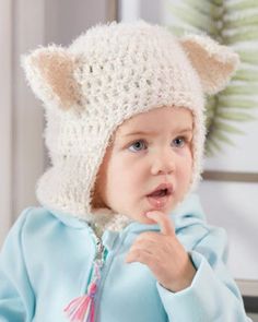 a young child wearing a knitted cat hat