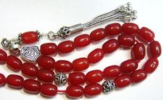 "Special from Swancollection : a magnificient Greek Komboloi - Worry beads Description : 1) Material : RED RUBILITE OF PRIME QUALITY 2) Tassel : Sterling Silver 3) General : 33 Oval beads Length 9 mm & Dia. 2mm 4) Sterling silver separators, Sterling shield and bead caps are in Sterling tassel Pictures describe best FREE SHIPPING WORLDWIDE This is a magnificient item that you will greatly enjoy or that would make a fantatstic gift on any occasion. My selling principle is : \" SATISFACTION OR Worry Beads, Mom Photos, Islamic Prayer, Rosary Necklace, Oval Beads, Rosary Catholic, Close To My Heart, Bead Caps, Pandora Charm Bracelet