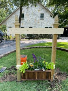 a wooden planter sitting on top of a lush green field