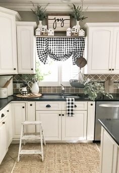 a little boy that is standing on a step stool in the middle of a kitchen