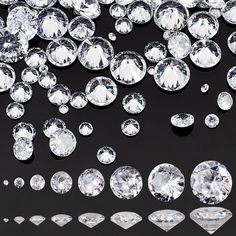 many different sizes and shapes of diamonds on a black surface