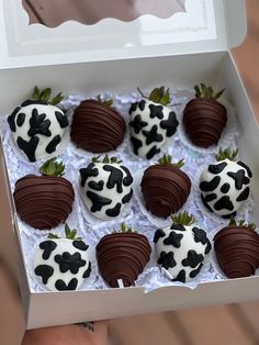 chocolate covered strawberries in a white box with black and white designs on them are ready to be eaten