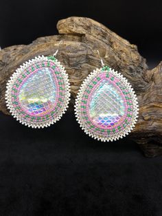 Beautifully hand beaded teardrop shaped 2 1/2 inch x 2 inch hook earrings. Sparkling resin center surrounded by three rows of beautifully designed pink, green, gold, and white Czech glass seed beads.  Hypoallergenic hooks.  Real leather backing.  These come gift-ready in carboard Kraft jewelry box with descriptive card as shown. These amazing earrings were handcrafted for Creator's Place by Amy Thompson, a Pine Point tribal artisan living on the White Earth Nation reservation n Northern Minnesota. Multicolor Beaded Teardrop Earrings, Multicolor Teardrop Beaded Earrings, Multicolor Teardrop Faceted Bead Jewelry, Pink Teardrop Beaded Earrings, Handmade Multicolor Teardrop Earrings, Multicolor Teardrop Jewelry For Crafting, Handmade Multicolor Teardrop Drop Earrings, Handmade Multicolor Drop Teardrop Earrings, Teardrop Beaded Earrings For Jewelry Making