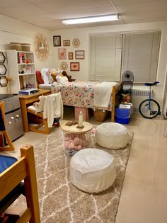 a bedroom with various furniture and decor in it