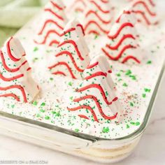 some white and red candy canes in a tin