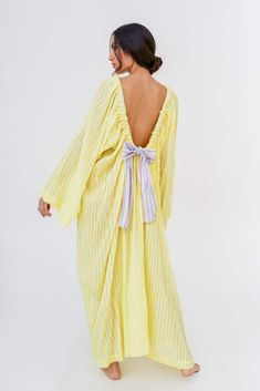 The maxi-length Open Back Bow Dress is made with our soft and delicate cotton gauze fabric, featuring long bell sleeves and an adjustable open back tied with a thick rainbow ribbon. Spring Maxi Dress With Elastic Sleeves, Spring Maxi Dress With Back Tassel Tie-up, Spring Dresses With Elastic Sleeves For Dress Down Occasions, Spring Dresses With Elastic Sleeves For Casual Occasions, Spring Party Maxi Dress With Gathered Sleeves, Spring Dresses With Back Tassel Tie-up, Spring Daywear Maxi Dress With Elastic Sleeves, Spring Long Dress With Elastic Sleeves, Maxi Dress With Smocked Cuffs For Brunch