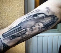 a man's arm with a car on it and clouds coming out of the back