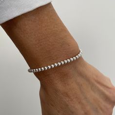 The sterling silver lariat ball bracelet is a fully adjustable lariat bracelet, making it the perfect fit for virtually any size wrist. Beautiful on its own or layered with other bracelets, it's an elegant and versatile piece for any occasion. The bead to tighten or loosen the bracelet adjusts effortlessly along the chain.    💖 Details 925 Sterling Silver Balls: approx 3 mm 💕 Online store: www.thejewellerytree.net 💕 If you like the jewellery, FOLLOW ME to stay up-to-date with new designs & special offers  Socials: @myjewellerytree OR  https://www.facebook.com/thejewellerytree1/  💕 Need more info, feel free to email - I'd love to help 💕And please visit my store https://www.etsy.com/au/shop/TheJewelleryTreeCo to see lots more quality sterling silver and gemstone jewellery We care about Adjustable White Gold Beaded Bracelets, Adjustable White Gold Beaded Bracelet, Adjustable Charm Bracelet With Spacer Beads, Adjustable Spacer Beads Charm Bracelet, Adjustable Hypoallergenic Sterling Silver Bracelet With Round Beads, Adjustable Sterling Silver Charm Bracelet With Round Beads, Sterling Silver Adjustable Charm Bracelet, Adjustable Silver Pearl Bracelet For Everyday, Adjustable Hand-strung Sterling Silver Bracelet