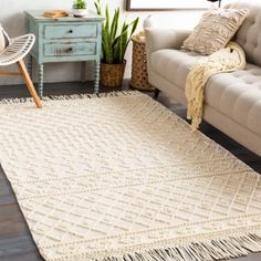 a living room with a couch, chair and rug