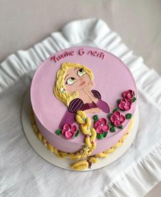 there is a pink cake with a princess on it