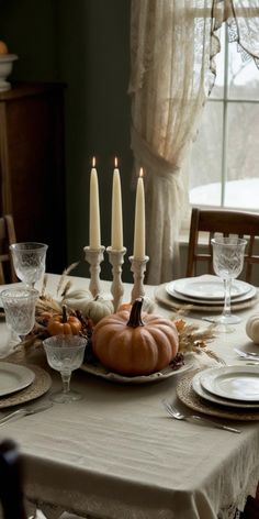 a dining room table set for thanksgiving dinner